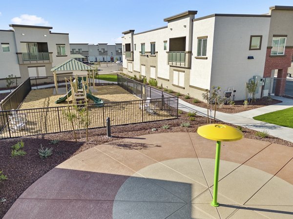 Outdoor recreational area with seating and greenery at Cardinal 95 Apartments