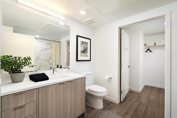 Bathroom featuring modern fixtures and elegant tilework in The Hayden Apartments