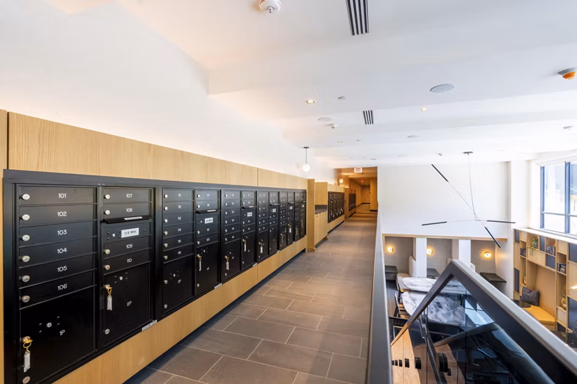 Mailroom with sleek design and individual mail slots at The Hayden Apartments, showcasing a convenient amenity for residents