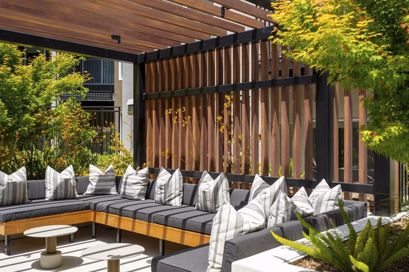 Courtyard featuring lush landscaping and seating at The Hayden Apartments