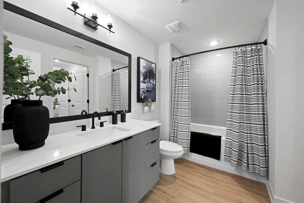Modern bathroom with sleek fixtures and marble countertop at Elan Polo Gardens Apartments
