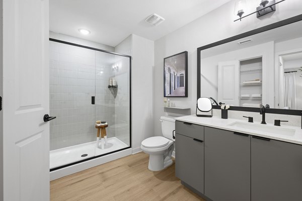 Modern bathroom with marble countertops and stylish fixtures in Elan Polo Gardens Apartments