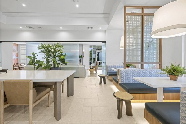 Modern clubhouse with elegant furnishings at Elan Polo Gardens Apartments, offering luxury living and community spaces for relaxation and socializing