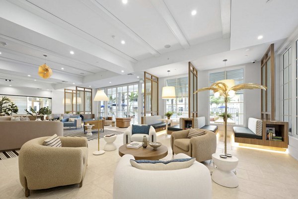 Clubhouse with modern design at Elan Polo Gardens Apartments featuring comfortable seating and social spaces