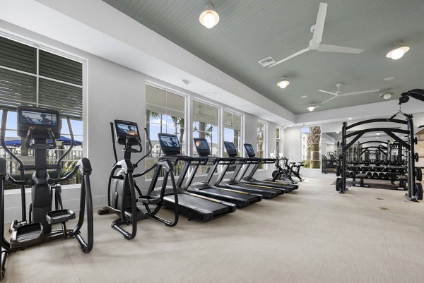 Fitness center with modern equipment at Elan Polo Gardens Apartments, offering a comprehensive workout experience