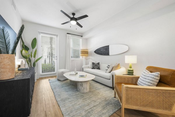Spacious living room with modern decor and natural light in Prado Apartments