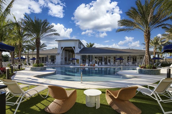 Elan Polo Gardens: Refreshing pool with lounge chairs at luxury apartments in peaceful neighborhood