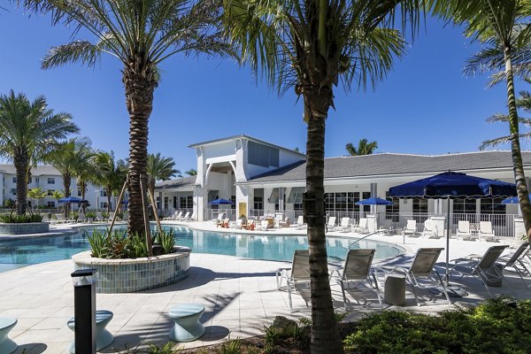 Resort-style pool at Elan Polo Gardens Apartments with lush landscaping for luxury living in a serene environment