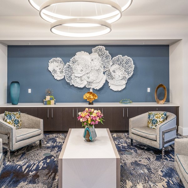 Clubhouse lounge area featuring modern decor and seating at Overture Doral Apartments in Miami, welcoming residents and guests