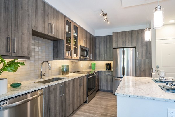 Modern kitchen with sleek countertops and stainless steel appliances at Overture Doral Apartments