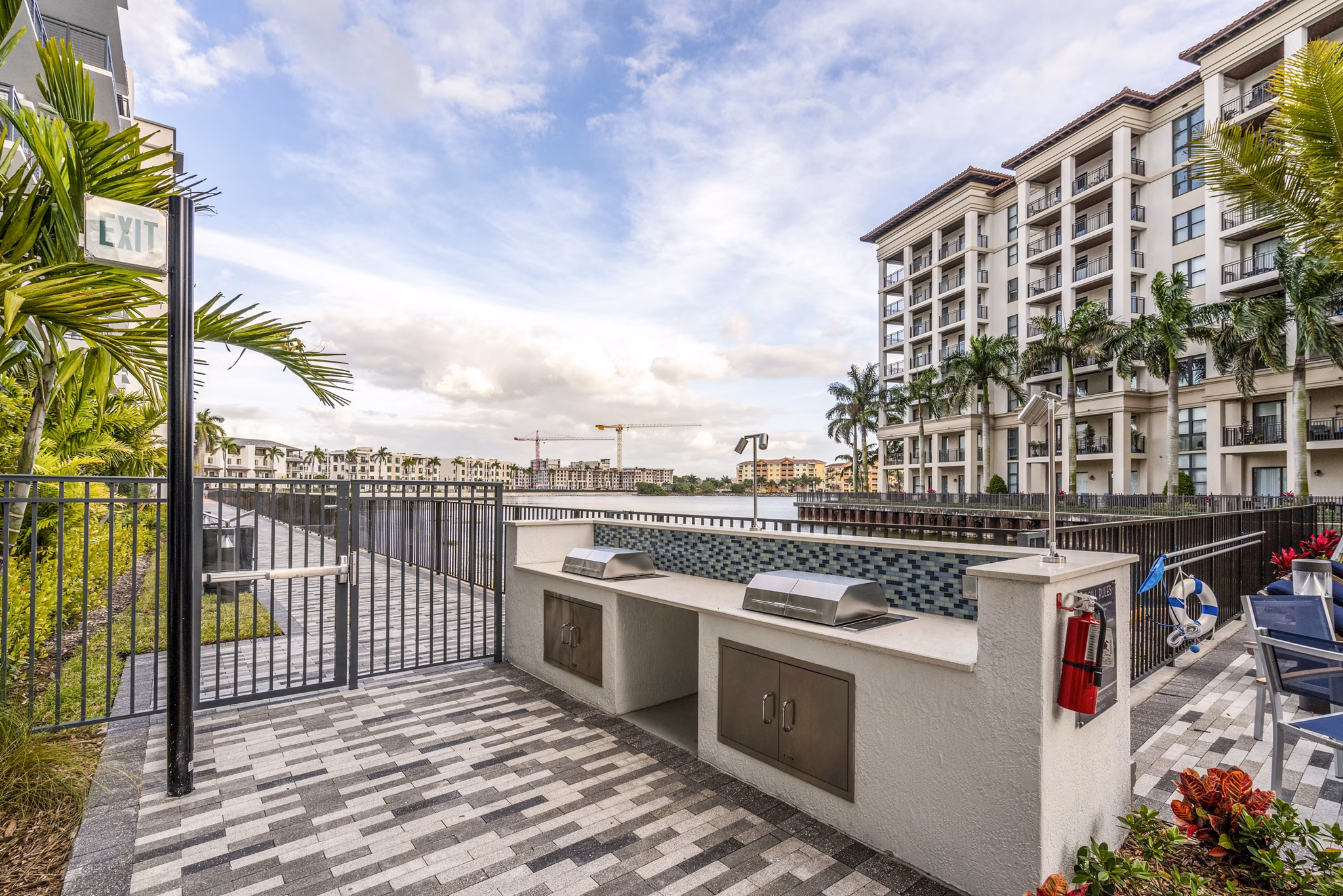Outdoor grill area with modern seating at Overture Doral Apartments, luxury living by Greystar