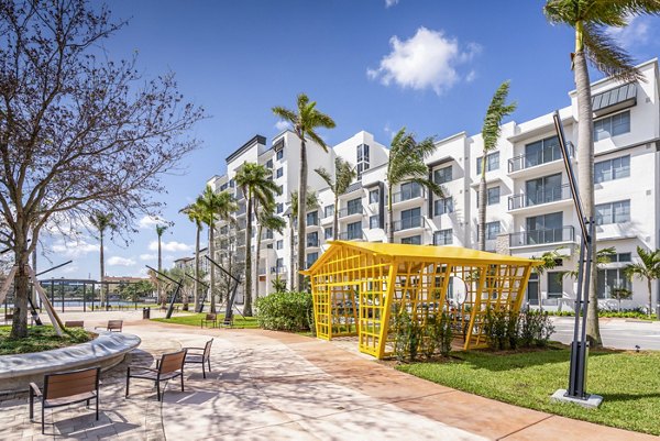 Relaxing patio with modern seating and lush greenery at Overture Doral Apartments, offering luxury outdoor living spaces to enjoy