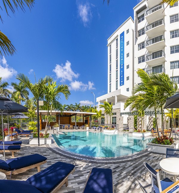 Outdoor pool with lounge seating at Overture Doral Apartments catering to a luxury lifestyle