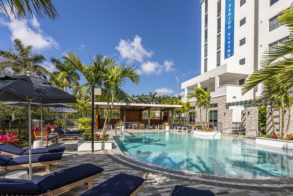 Resort-style pool at Overture Doral Apartments featuring cabanas and underwater lighting