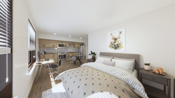 Bedroom with elegant decor and large windows at Hagert and York Apartments, offering luxurious living in a Greystar community