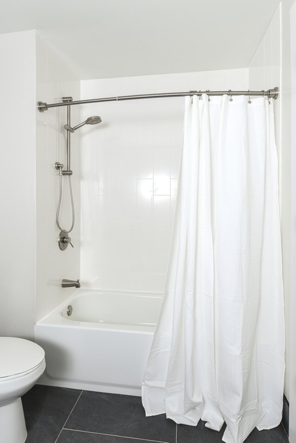 Modern bathroom featuring marble countertops and glass shower at Hagert and York Apartments