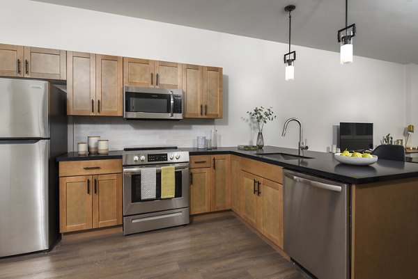 Modern kitchen with sleek finishes and stainless-steel appliances at Hagert and York Apartments, luxury living by Greystar