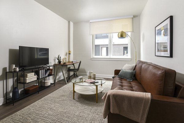 Spacious living room with contemporary furnishings at Hagert and York Apartments in Greystar luxury community