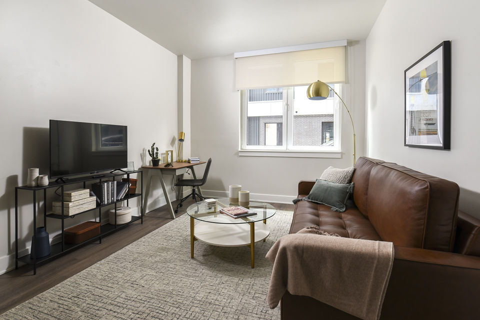 Spacious living room with contemporary furnishings at Hagert and York Apartments in Greystar luxury community