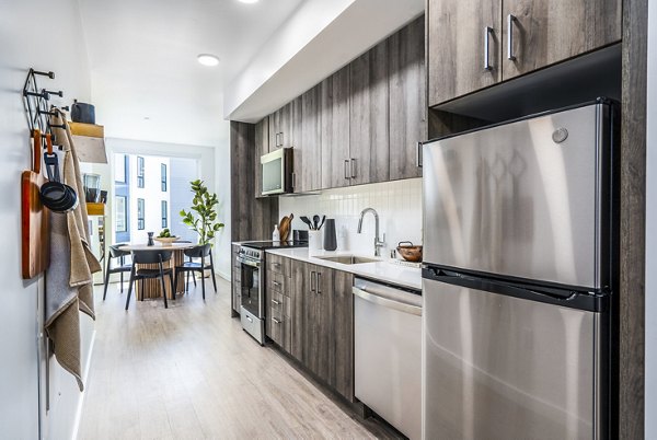 Modern kitchen with stainless steel appliances and granite countertops at Ventana Residences Apartments