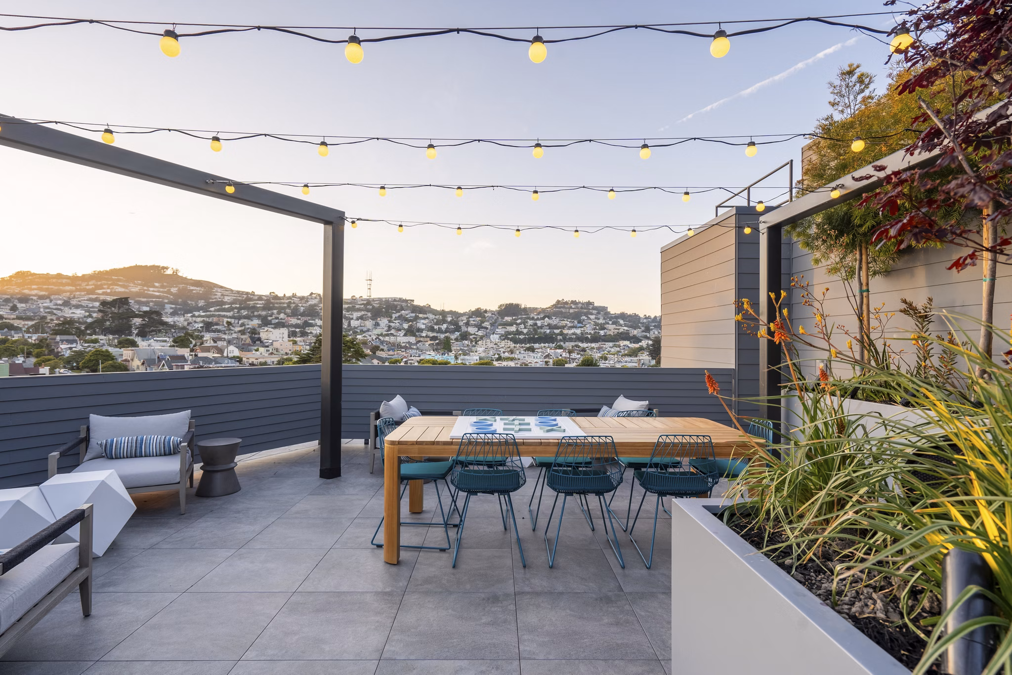 Inviting outdoor patio at Ventana Residences Apartments with modern furniture and lush greenery