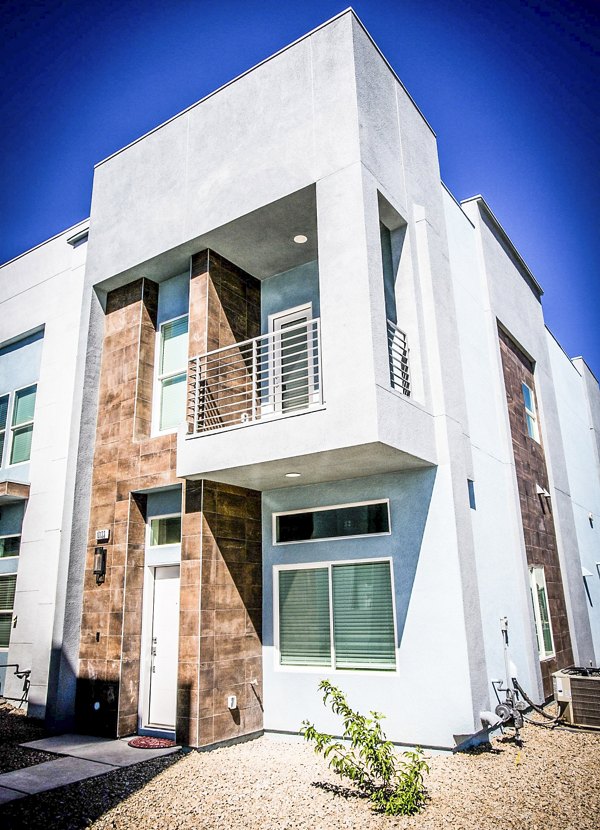 Townes at Peace Way Apartments: Elegant building with lush landscaping, showcasing luxury living in a premier location