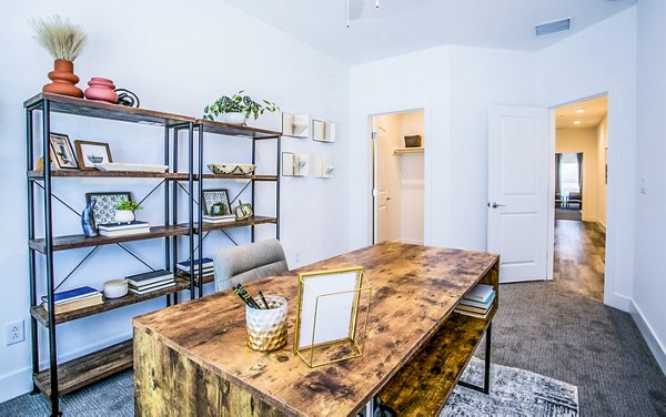 Cozy bedroom with chic home office setup at Townes at Peace Way Apartments