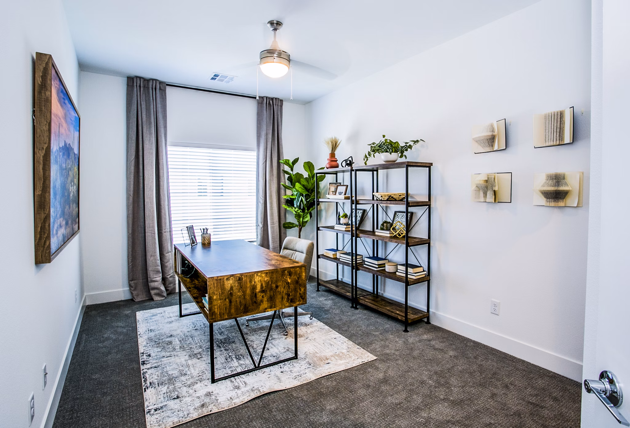 Bright bedroom with versatile home office setup in Townes at Peace Way Apartments