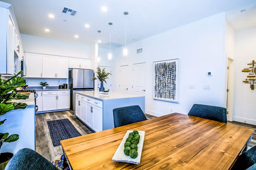 Dining room with modern decor and hardwood floors in Townes at Peace Way Apartments