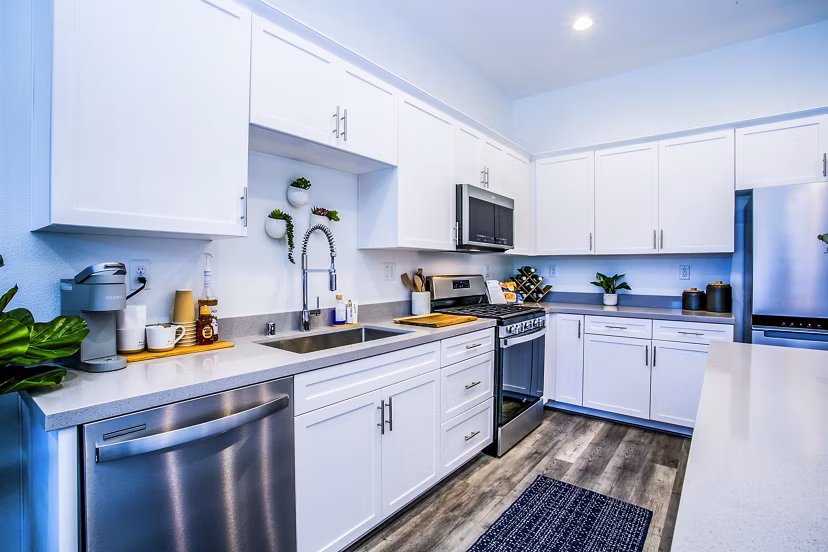 Modern kitchen with granite countertops in Townes at Peace Way Apartments