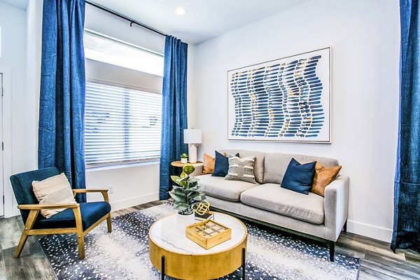 Spacious living room with modern decor in Townes at Peace Way Apartments