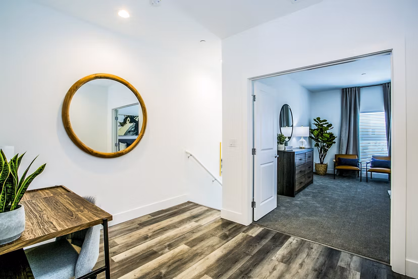 Modern hallway with sleek lighting and hardwood floors at Townes at Peace Way Apartments