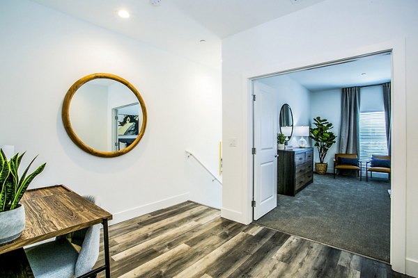 Modern hallway with sleek lighting and hardwood floors at Townes at Peace Way Apartments