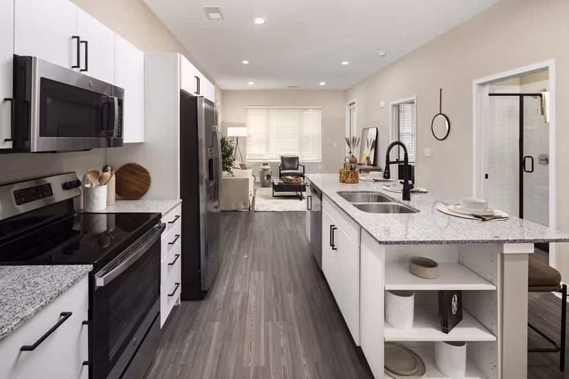 Modern kitchen with stainless steel appliances at The Crossings Apartments