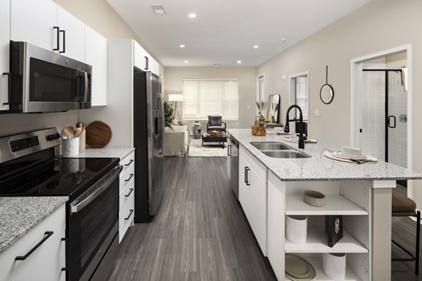 Modern kitchen with stainless steel appliances at The Crossings Apartments