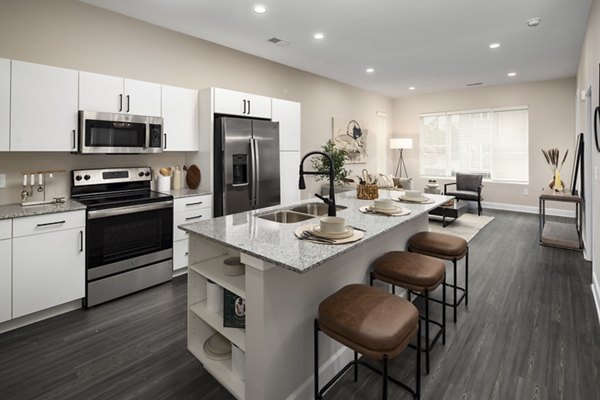 Modern kitchen with stainless steel appliances at The Crossings Apartments