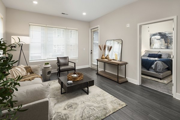 Modern living room with plush seating and large windows at The Crossings Apartments