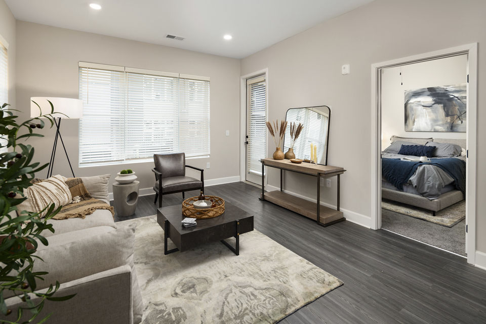 Modern living room with plush seating and large windows at The Crossings Apartments
