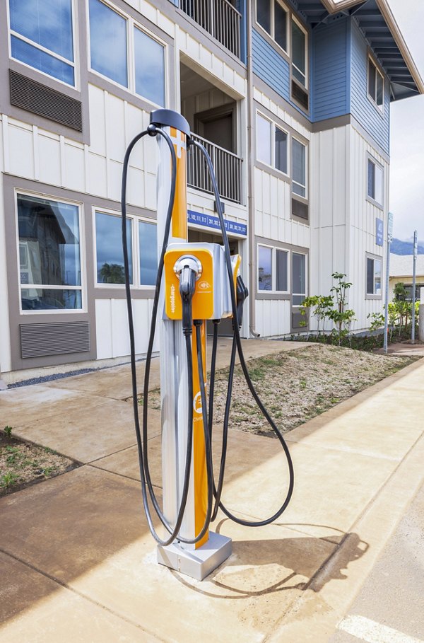 Electric car charging station at Kaulana Mahina Apartments offering sustainable living amenities