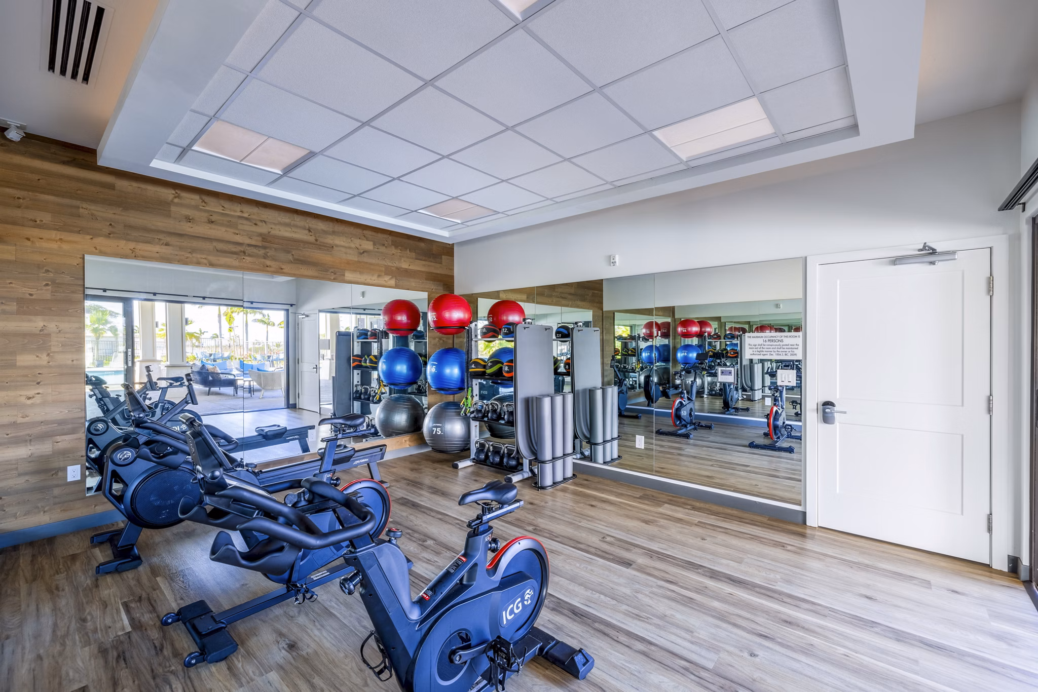 State-of-the-art fitness center at Kaulana Mahina Apartments featuring modern exercise equipment and spacious workout areas for residents