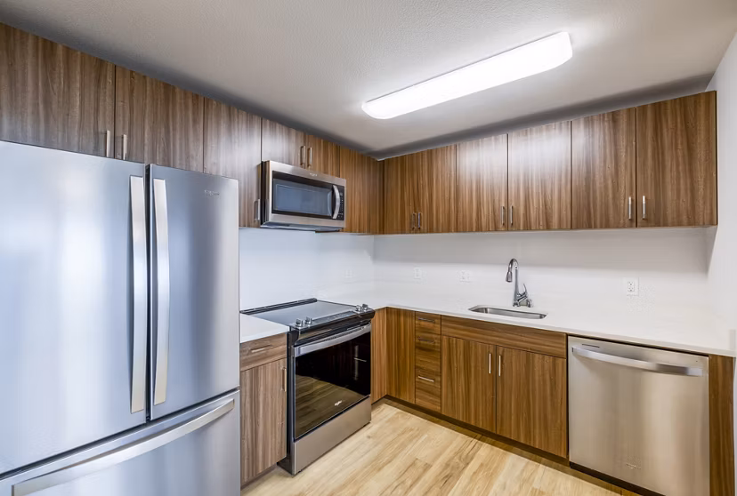 Modern kitchen featuring sleek countertops and stainless steel appliances in Kaulana Mahina Apartments