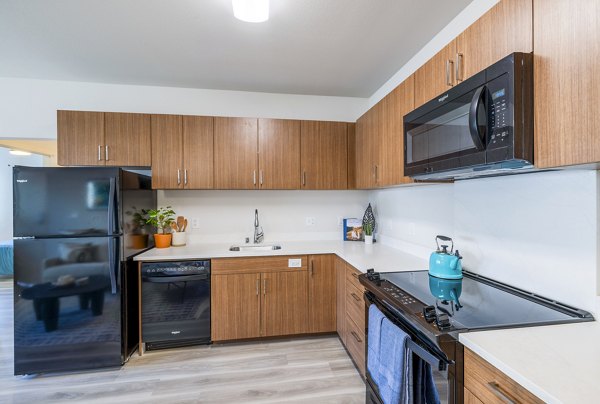 Modern kitchen with sleek countertops and stainless steel appliances in Kaulana Mahina Apartments