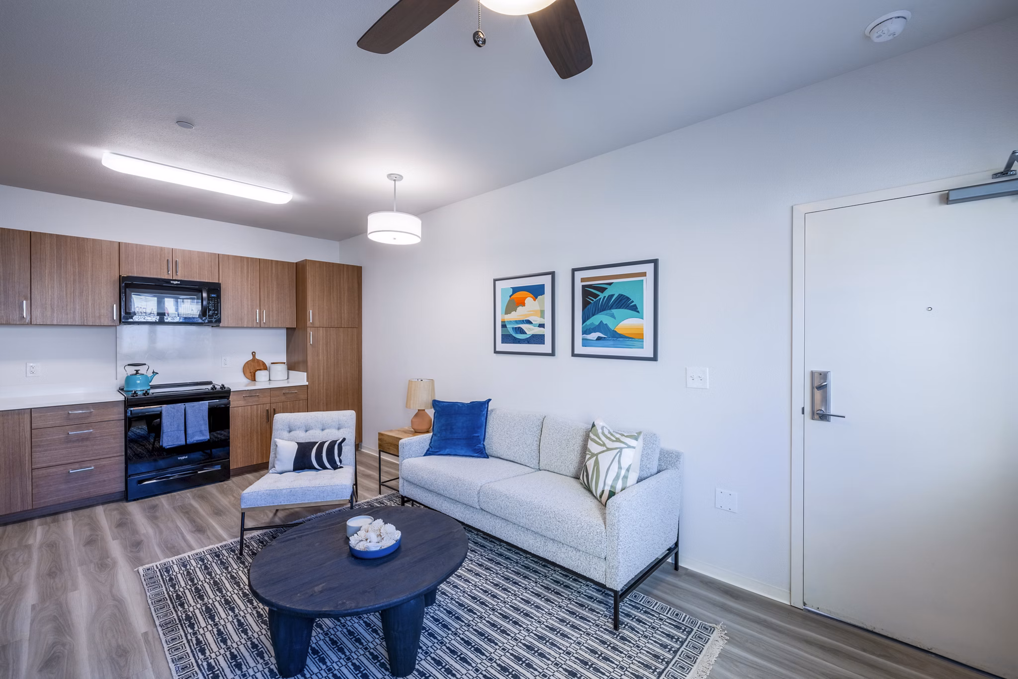 Contemporary living room with sleek furnishings and natural light at Kaulana Mahina Apartments