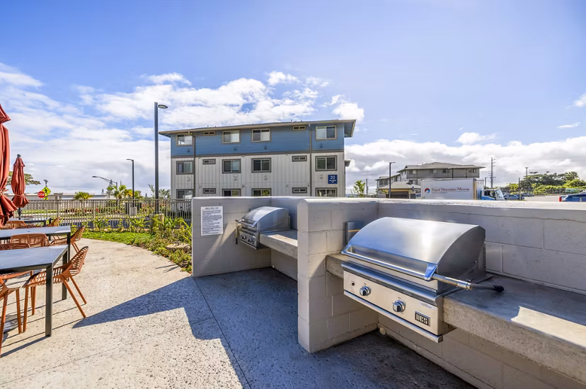 Grill and patio area at Kaulana Mahina Apartments offering outdoor dining spaces