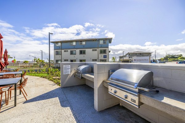 Grill and patio area at Kaulana Mahina Apartments offering outdoor dining spaces