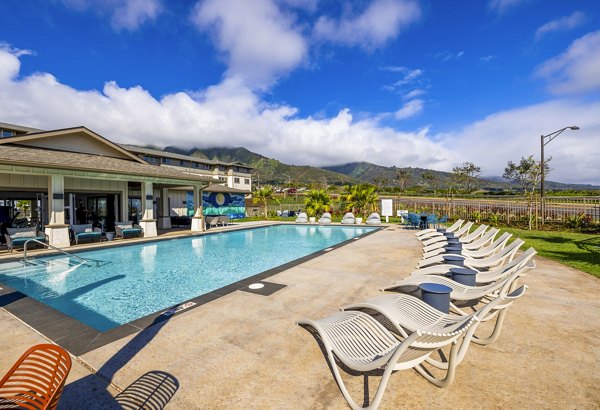 Infinity-edge pool surrounded by lush greenery at Kaulana Mahina Apartments