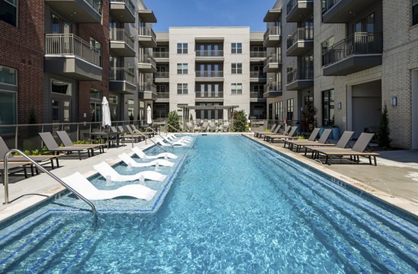 Resort-style pool at The International at Valley Ranch Apartments, offering luxury relaxation and recreation amenities