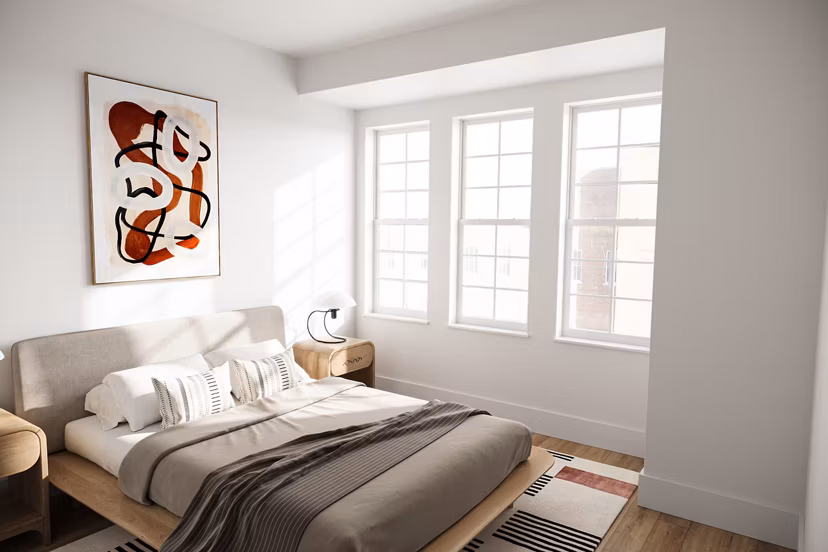 Spacious bedroom with modern decor and large windows at Shoregate Apartments