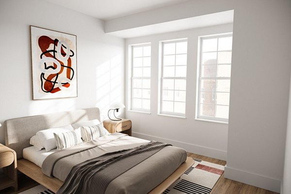 Spacious bedroom with modern decor and large windows at Shoregate Apartments