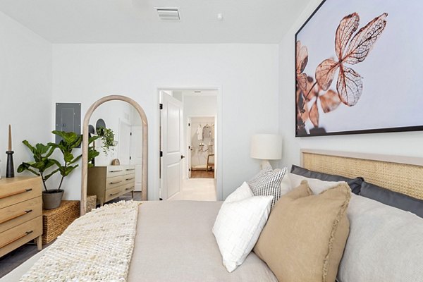 Cozy bedroom featuring modern decor and ample natural light at Soluna Apartments